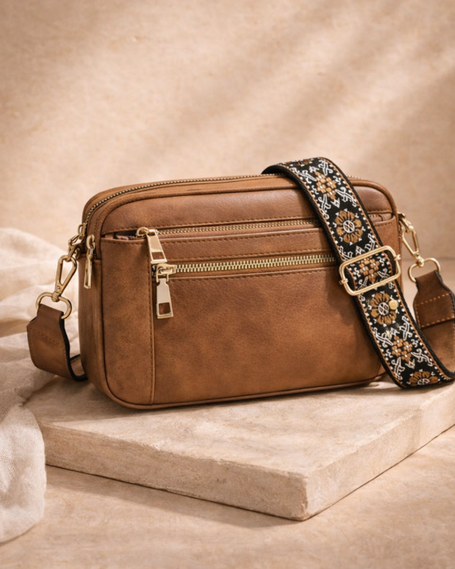 Black FJØRNA refined leather shoulder bag for women, stylish and compact with a sleek design and shoulder strap.