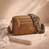 Black FJØRNA refined leather shoulder bag for women, stylish and compact with a sleek design and shoulder strap.