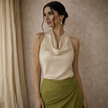 FJØRNA women's satin cowl neck sleeveless top in cream, featuring a smooth fabric and elegant mock neck design.