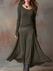 Charcoal knit maxi dress for women by FJØRNA, featuring a long, flowing silhouette and cozy textured fabric.