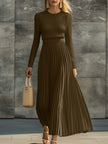 Cream satin pleated maxi dress by FJØRNA featuring a flowing design and elegant pleats. Perfect for casual or formal wear.