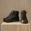 Men's black high-top leather Chelsea boots with side zipper from FJØRNA, stylish and durable footwear for men.