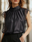 FJØRNA black chiffon high-neck sleeveless blouse for women, elegant top with a flowing fabric and high neckline.