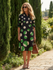 FJØRNA women's summer dress with polka dots, wrap style, flowy and breathable fabric, perfect for warm weather.