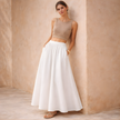 FJØRNA high-waist white A-line maxi skirt for women, flowy and elegant, shown from the front on a plain background.