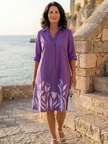 FJØRNA women's floral wrap evening dress with elegant design, featuring a fitted waist and flowing skirt for special occasions.