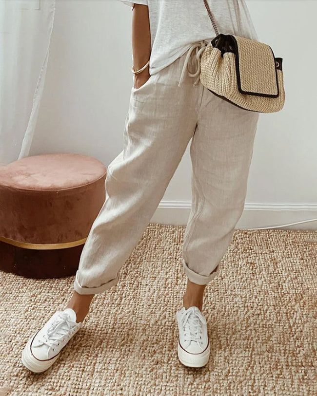 FJØRNA lightweight summer women's trousers with straight leg cut and high waist, shown in soft fabric on a model.