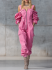 Pink denim strappy tapered long sleeve jumpsuit for women by FJØRNA, featuring a fitted waist and stylish long sleeves.