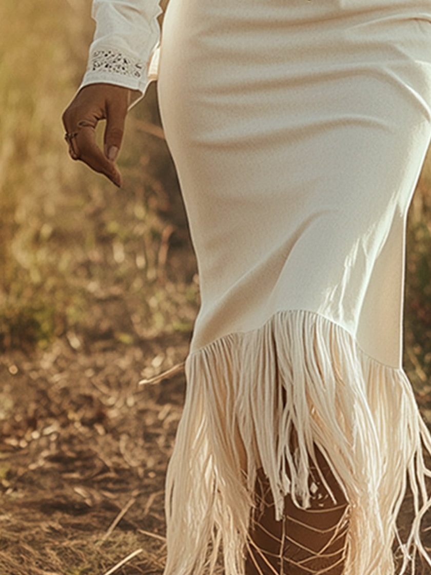White denim tassel maxi dress by FJØRNA showing flowy fabric, tassel details, and casual style perfect for summer wear