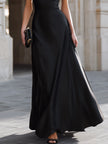 Black one-shoulder draped high-neck maxi dress by FJØRNA featuring elegant design and flowing fabric.