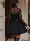 Black FJØRNA women's dress displayed on a hanger, featuring a sleek design suitable for casual or formal occasions.