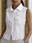 White sleeveless floral embroidery blouse for women by FJØRNA, featuring delicate floral details and a stylish sleeveless design.