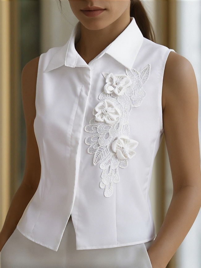 White sleeveless floral embroidery blouse for women by FJØRNA, featuring delicate floral details and a stylish sleeveless design.