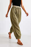 FJØRNA women's linen tapered trousers, lightweight and stylish pants with a relaxed fit, shown in a neutral fabric color.