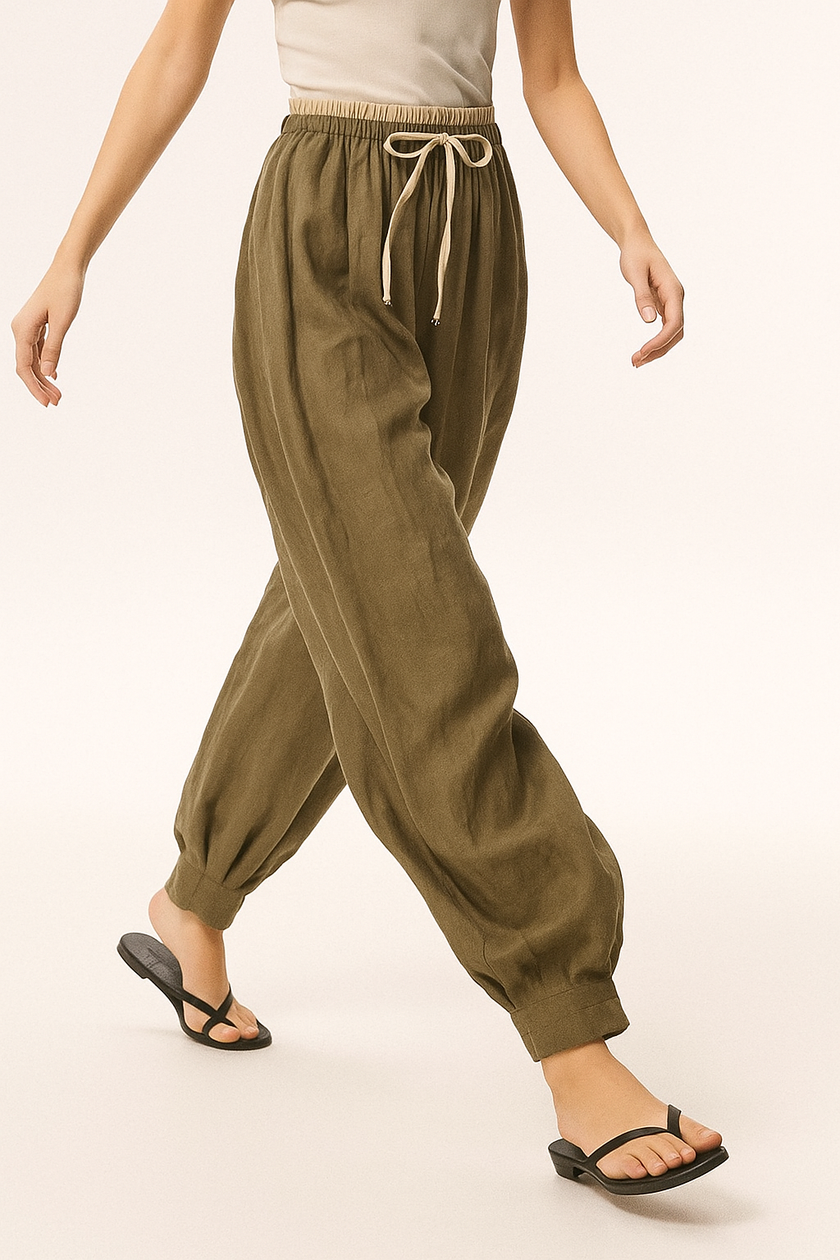 FJØRNA women's linen tapered trousers, light and breathable pants with a relaxed fit, shown in natural linen fabric.