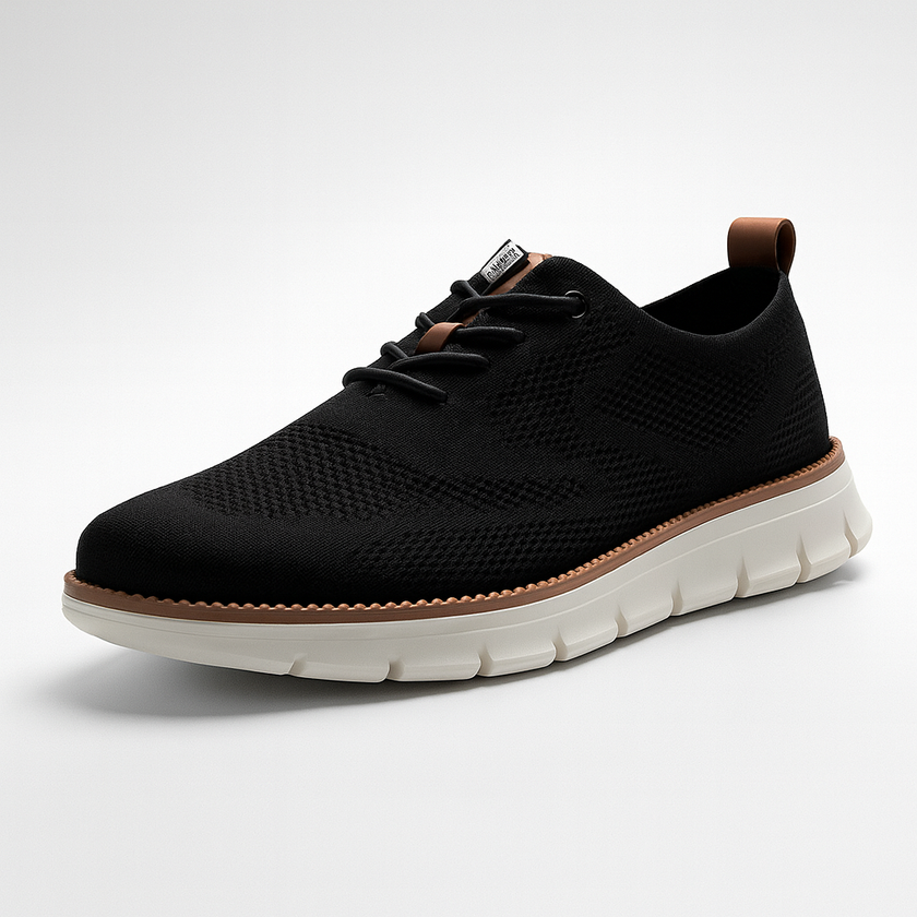 Men's breathable knit mesh trainers by FJØRNA with cushioned waffle-pod sole, displayed on a sleek shoe stand.
