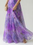 FJØRNA women's sleeveless summer maxi dress with wrap design, flowing fabric, and vibrant print, ideal for warm weather wear.