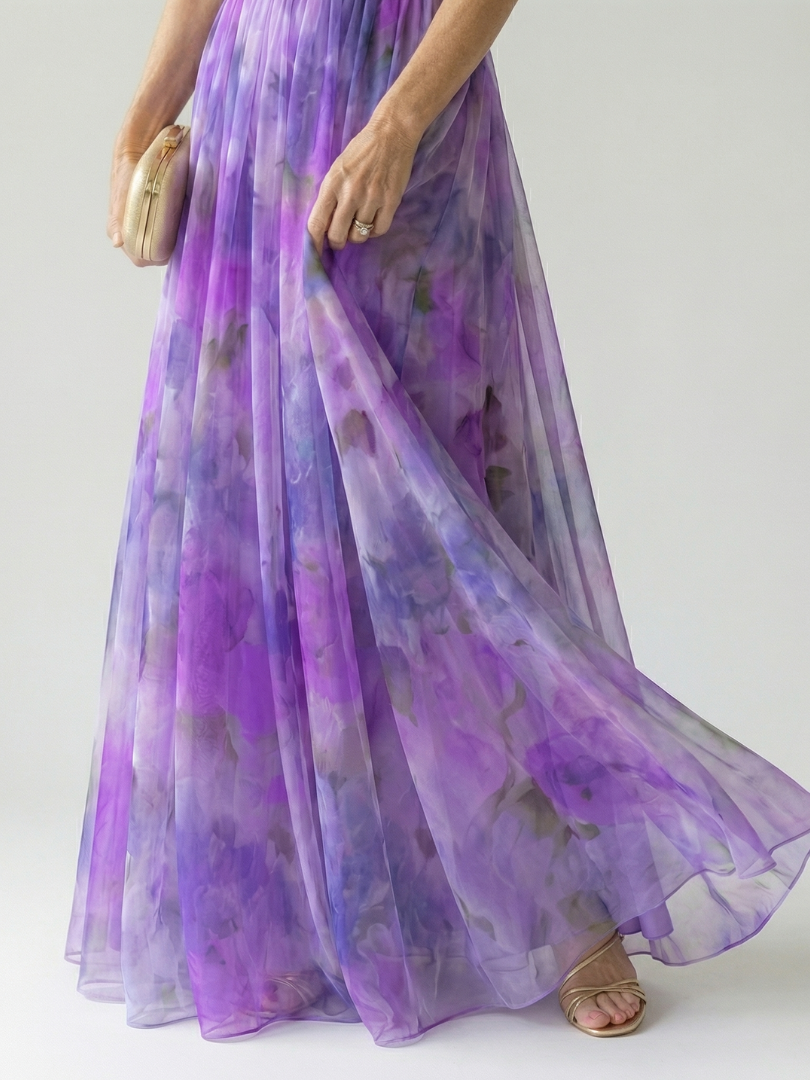 FJØRNA women's sleeveless summer maxi dress with wrap design, flowing fabric, and vibrant print, ideal for warm weather wear.