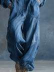 Blue denim FJØRNA women's hooded button-front long sleeve jumpsuit with long pants and casual style.