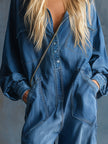 Blue denim hooded jumpsuit with button-front long sleeves, designed for women by FJØRNA, shown on a model.