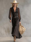 Black denim V-neck maxi dress by FJØRNA, featuring a casual style with a flowing silhouette and sleeveless design.