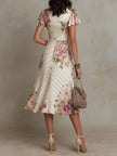 FJØRNA chiffon floral midi dress with a flowing design, perfect for evening occasions, featuring a vibrant floral pattern.