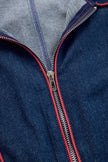 Dark blue FJØRNA women's denim jumpsuit with wide-leg pants, topstitched detailing, and long sleeves, displayed on a hanger.