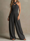 FJØRNA charcoal pinstripe halter neck wide-leg women's jumpsuit with tailored pants and a stylish halter top design.