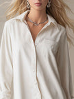 White denim ruffle midi dress by FJØRNA featuring a fitted bodice, ruffled details, and a flowy midi length perfect for evening wear.
