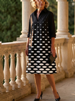 FJØRNA elegant women's polka dot dress with pockets, featuring a fitted waist and classic design, ideal for stylish occasions.
