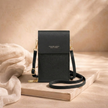FJØRNA touchscreen crossbody phone bag for women, compact bag with transparent phone pocket and adjustable strap, stylish and functional.