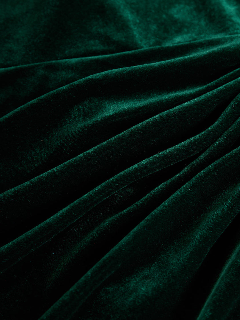 FJØRNA velvet midi evening dress showing a fitted waist and elegant flowy skirt on a model.
