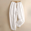 FJØRNA women's linen tapered trousers, stylish and comfortable pants with a relaxed fit, shown in natural fabric and neutral color.