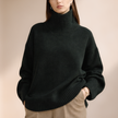 FJØRNA women's wool turtleneck sweater in cozy knit, featuring a classic design and ribbed collar.