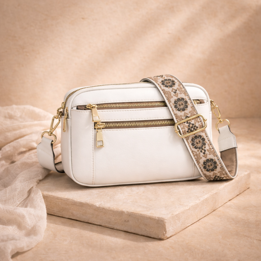 Black FJØRNA leather shoulder bag for women, showcasing a sleek, refined design with adjustable strap and minimalist style.