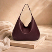 Large leather hobo bag for women by FJØRNA, featuring a spacious design with top handles, casual style, and soft brown leather.