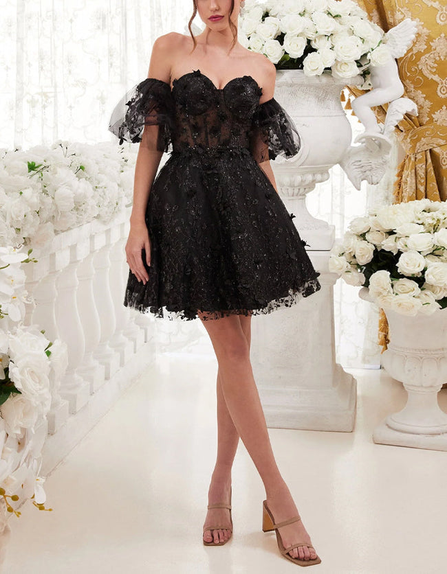 Black tulle cocktail dress for women with floral puff sleeves by FJØRNA, showcasing elegant design and delicate fabric details.