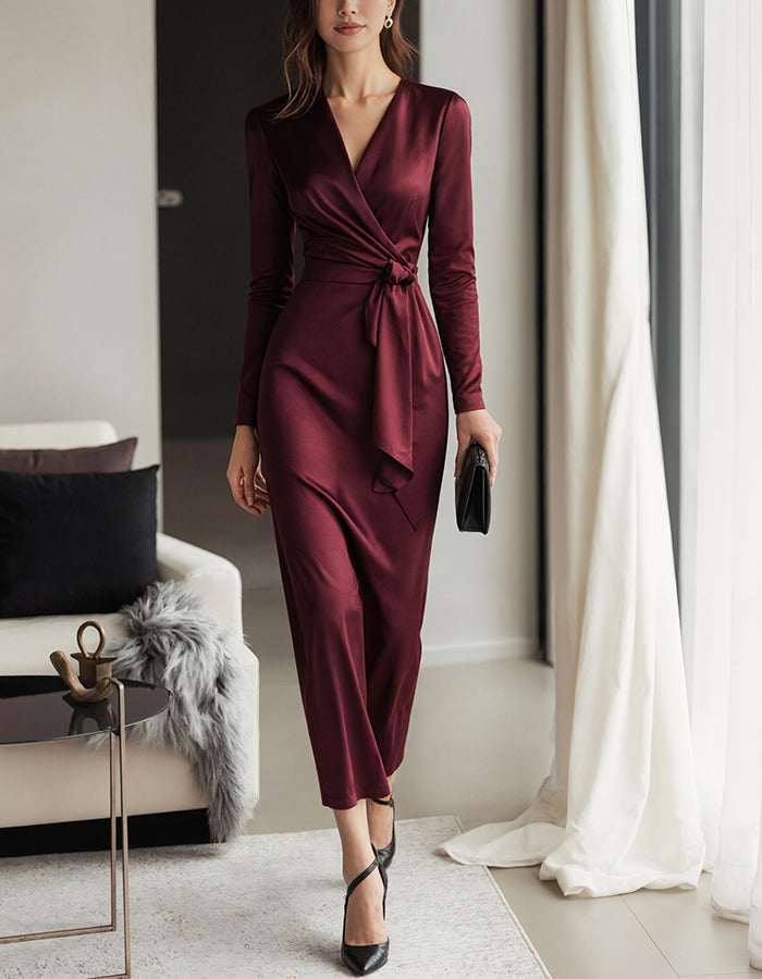 Burgundy satin midi dress for women with V-neck, mermaid silhouette, long sleeves, by FJØRNA, displayed on a hanger.