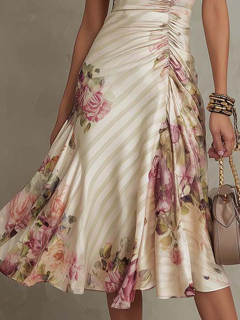 FJØRNA chiffon floral midi dress for evening wear, featuring a flowy silhouette and vibrant floral pattern.