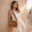 Black FJØRNA leather shoulder bag for women, stylish and refined with a sleek design and adjustable strap.