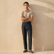 FJØRNA men's blue straight-leg cotton trousers with slim fit, classic chino style, shown on a model against a neutral background.