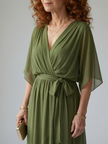 Flowy FJØRNA summer midi dress for women with V-neck, lightweight fabric, and relaxed fit suitable for warm weather.