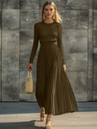 Cream satin pleated maxi dress by FJØRNA featuring a flowing silhouette and elegant pleats, perfect for casual or formal occasions.