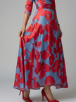 FJØRNA women's floral summer maxi dress with V-neck wrap design, flowing fabric, and vibrant floral pattern.