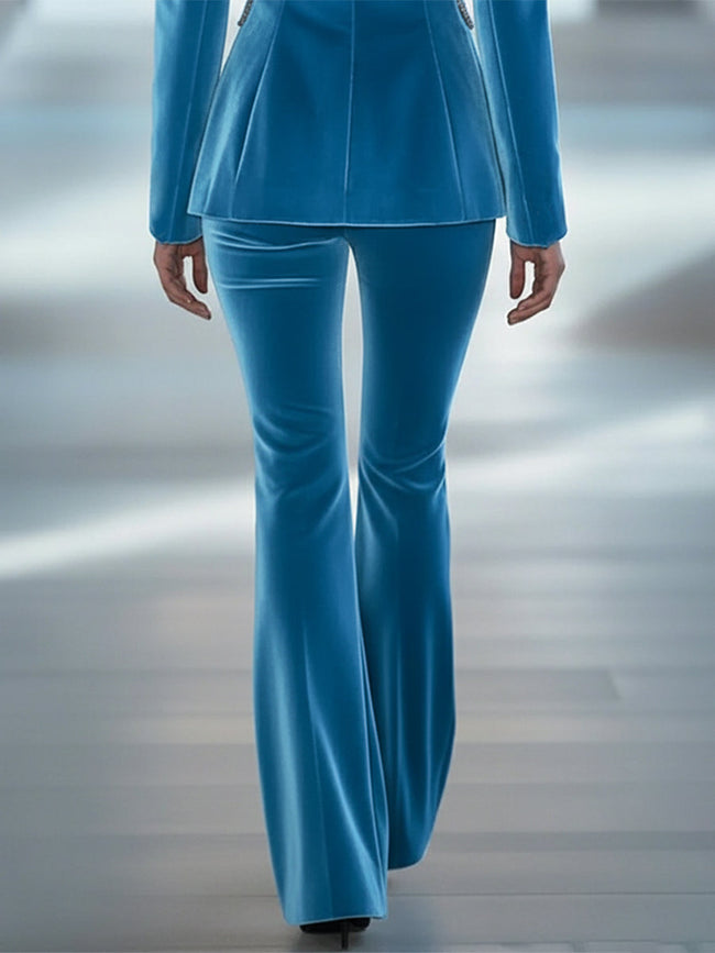 Blue loose velvet flared trousers for women by FJØRNA, showing the relaxed fit and wide-legged style on a neutral background.