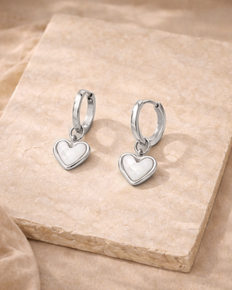 Silver FJØRNA White Quartz Heart Huggie Earrings for women, featuring heart-shaped white quartz stones and sleek hoop design.