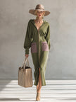 Green long sleeve maxi dress by FJØRNA, elegant evening dress with flowing fabric and fitted waist, shown on a model.