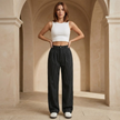 FJØRNA pinstripe high-waisted wide-leg women's trousers laid flat, showcasing tailored design and classic pinstripe pattern.
