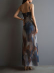 FJØRNA chiffon maxi dress for women featuring a retro design, flowing fabric, and elegant style.