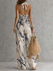 White ink wash print halter neck wide-leg women's jumpsuit with pockets by FJØRNA, shown on a model.